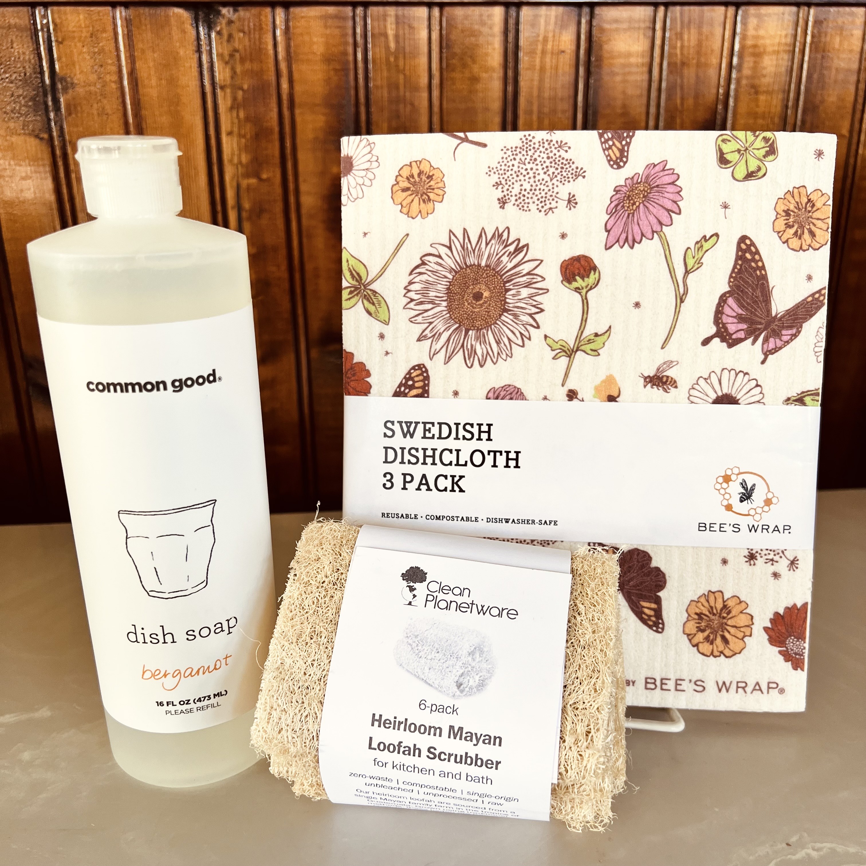 Pictured: Common Good Dish Soap, Bee's Wrap Swedish Dishcloth and Clean Planetware Loofah Scrubber.